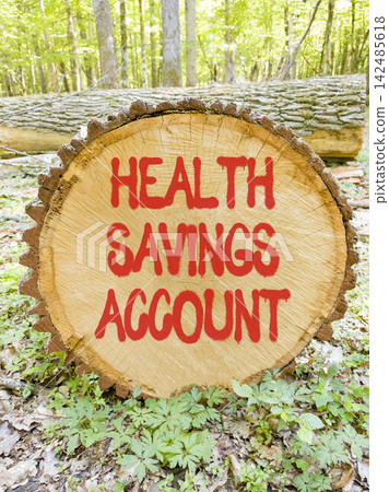Health saving account symbol. Concept words Health saving account on beautiful wooden circle. Beautiful green forest background. Medical Health saving account concept. Copy space. 142485618