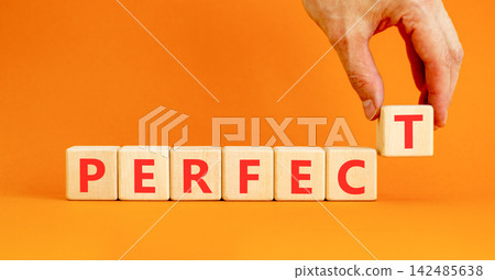 Perfect word symbol. Concept word Perfect on beautiful wooden blocks. Beautiful orange table orange background. Businessman hand. Business perfect word concept. Copy space. Perfect word symbol. Concept word Perfect on beautiful wooden blocks. Beautiful orange table orange background. Businessman hand. Business perfect word concept. Copy space. 142485638