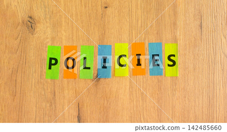 Policies word symbol. Concept word Policies on beautiful colored papers. Beautiful wooden background. Business support help policies word concept. Copy space. Policies word symbol. Concept word Policies on beautiful colored papers. Beautiful wooden background. Business support help policies word concept. Copy space. 142485660