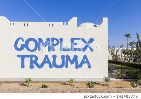 Complex trauma words symbol. Concept words Complex trauma on beautiful white wall. Beautiful blue sky background. Psychological complex trauma support concept. Copy space. Complex trauma words symbol. Concept words Complex trauma on beautiful white wall. Beautiful blue sky background. Psychological complex trauma support concept. Copy space. 142485779