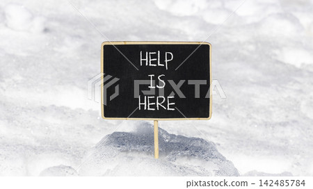 Help is here and support words symbol. Concept words Help is here on beautiful black blackboard. Beautiful white snow background. Business help is here and support concept. Copy space. Help is here and support words symbol. Concept words Help is here on beautiful black blackboard. Beautiful white snow background. Business help is here and support concept. Copy space. 142485784