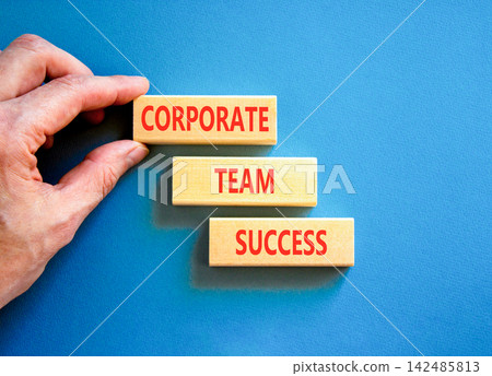 Corporate team success words symbol. Concept words Corporate team success on beautiful wooden blocks. Beautiful blue background. Businessman hand. Business corporate team success concept Copy space 142485813