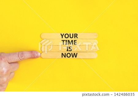 Your time is now symbol. Concept words Your time is now on beautiful wooden sticks. Beautiful yellow background. Businessman hand. Business support motivational your time is now concept. Copy space. Your time is now symbol. Concept words Your time is now on beautiful wooden sticks. Beautiful yellow background. Businessman hand. Business support motivational your time is now concept. Copy space. 142486035