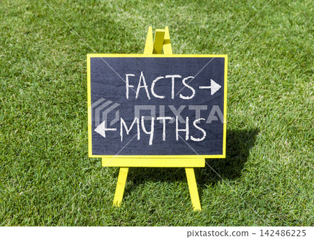 Facts or myths words symbol. Concept words Myths and Facts on yellow blackboard. Beautiful green grass background. Business and facts or myths concept. Copy space. Facts or myths words symbol. Concept words Myths and Facts on yellow blackboard. Beautiful green grass background. Business and facts or myths concept. Copy space. 142486225