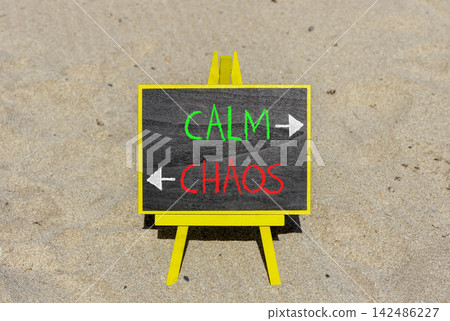 Calm instead chaos words symbol. Concept words Calm Chaos on beautiful yellow blackboard. Beautiful sand beach background. Business medical psychology calm chaos concept. Copy space. Calm instead chaos words symbol. Concept words Calm Chaos on beautiful yellow blackboard. Beautiful sand beach background. Business medical psychology calm chaos concept. Copy space. 142486227