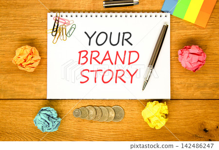 Branding and your brand story symbol. Concept words Your brand story on beautiful white note. Beautiful wooden background. Colored paper. Business branding your brand story concept. Copy space. 142486247