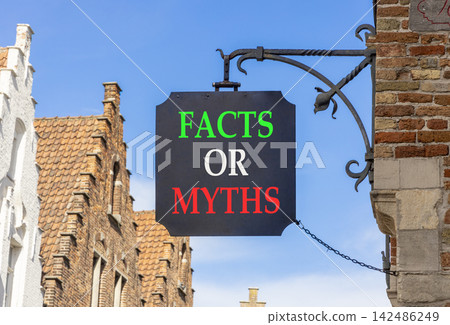 Facts or myths words symbol. Concept words Myths or Facts on beautiful black road sign. Beautiful blue sky Brugge street background. Business and facts or myths concept. Copy space. Facts or myths words symbol. Concept words Myths or Facts on beautiful black road sign. Beautiful blue sky Brugge street background. Business and facts or myths concept. Copy space. 142486249