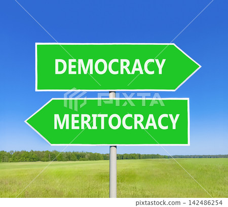 Democracy or meritocracy words symbol. Concept words Democracy Meritocracy on beautiful green road sign. Beautiful blue sky background. Business democracy meritocracy concept. Copy space Democracy or meritocracy words symbol. Concept words Democracy Meritocracy on beautiful green road sign. Beautiful blue sky background. Business democracy meritocracy concept. Copy space 142486254