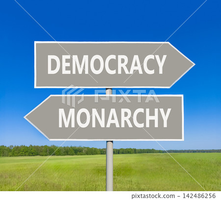 Democracy or monarchy words symbol. Concept words Democracy Monarchy on beautiful grey road sign. Beautiful blue sky background. Business democracy monarchy concept. Copy space Democracy or monarchy words symbol. Concept words Democracy Monarchy on beautiful grey road sign. Beautiful blue sky background. Business democracy monarchy concept. Copy space 142486256