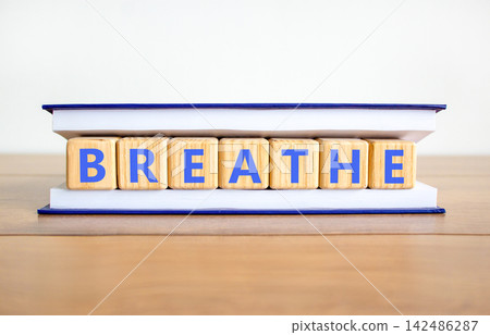 Breathe word symbol. Concept word Breathe on beautiful wooden blocks in book. Beautiful wooden table white background. Business medical breathe word concept. Copy space. Breathe word symbol. Concept word Breathe on beautiful wooden blocks in book. Beautiful wooden table white background. Business medical breathe word concept. Copy space. 142486287
