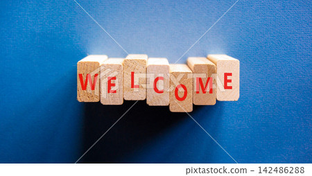 Welcome word symbol. Concept word Welcome on beautiful wooden blocks. Beautiful blue background. Business welcome word concept. Copy space. Welcome word symbol. Concept word Welcome on beautiful wooden blocks. Beautiful blue background. Business welcome word concept. Copy space. 142486288