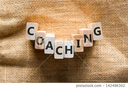 Coaching word symbol. Concept word Coaching on beautiful wooden blocks. Beautiful canvas background. Business support help coaching word concept. Copy space. Coaching word symbol. Concept word Coaching on beautiful wooden blocks. Beautiful canvas background. Business support help coaching word concept. Copy space. 142486302
