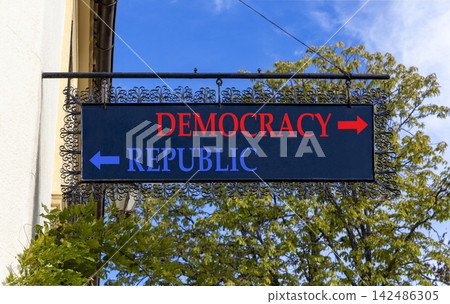 Democracy or republic words symbol. Concept words Democracy Republic on beautiful black road sign. Beautiful blue sky background. Business democracy republic concept. Copy space Democracy or republic words symbol. Concept words Democracy Republic on beautiful black road sign. Beautiful blue sky background. Business democracy republic concept. Copy space 142486305