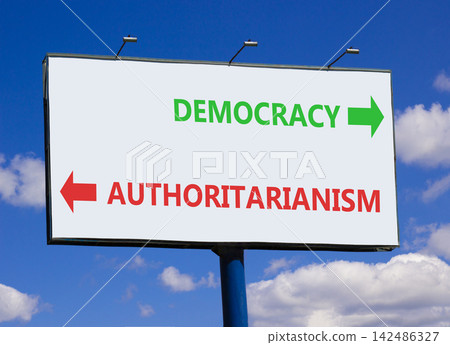 Democracy or authoritarianism symbol. Concept words Democracy Authoritarianism on beautiful white billboard. Beautiful blue sky background. Business democracy authoritarianism concept. Copy space Democracy or authoritarianism symbol. Concept words Democracy Authoritarianism on beautiful white billboard. Beautiful blue sky background. Business democracy authoritarianism concept. Copy space 142486327