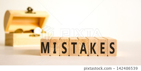 Mistakes mistake word symbol. Concept word Mistakes on beautiful wooden blocks. Beautiful white background. Beautiful chest with coins. Business support help mistakes mistake word concept. Copy space. 142486539