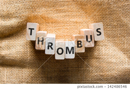 Thrombus word symbol. Concept word Thrombus on beautiful wooden blocks. Beautiful canvas background. Business medical support help thrombus word concept. Copy space. 142486546
