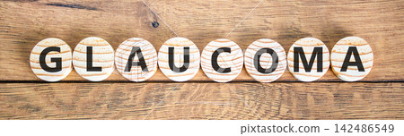 Glaucoma word symbol. Concept word Glaucoma on beautiful wooden circles. Beautiful wooden background. Medical support help glaucoma word concept. Copy space. Glaucoma word symbol. Concept word Glaucoma on beautiful wooden circles. Beautiful wooden background. Medical support help glaucoma word concept. Copy space. 142486549