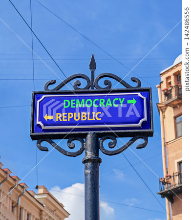 Democracy or republic words symbol. Concept words Democracy Republic on beautiful blue road sign. Beautiful blue sky background. Business democracy republic concept. Copy space Democracy or republic words symbol. Concept words Democracy Republic on beautiful blue road sign. Beautiful blue sky background. Business democracy republic concept. Copy space 142486556