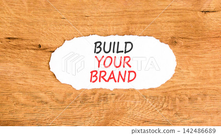 Build your brand words symbol. Concept words Build your brand on beautiful white paper. Beautiful wooden background. Business and build your brand concept. Copy space. Build your brand words symbol. Concept words Build your brand on beautiful white paper. Beautiful wooden background. Business and build your brand concept. Copy space. 142486689