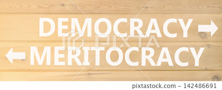 Democracy or meritocracy words symbol. Concept words Democracy Meritocracy on beautiful wooden wall. Beautiful wooden wall background. Business democracy meritocracy concept. Copy space Democracy or meritocracy words symbol. Concept words Democracy Meritocracy on beautiful wooden wall. Beautiful wooden wall background. Business democracy meritocracy concept. Copy space 142486691