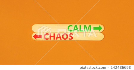 Calm instead chaos words symbol. Concept words Calm Chaos on beautiful wooden sticks. Beautiful orange background. Business medical psychology calm chaos concept. Copy space. 142486698