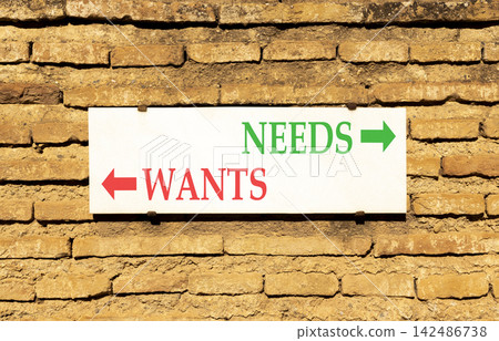 Needs instead wants words symbol. Concept words Needs Wants on beautiful white sign plate. Beautiful brick wall background. Business psychology needs or wants concept. Copy space. Needs instead wants words symbol. Concept words Needs Wants on beautiful white sign plate. Beautiful brick wall background. Business psychology needs or wants concept. Copy space. 142486738