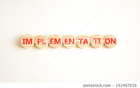 Implementation word symbol. Concept word Implementation on beautiful wooden circles. Beautiful white background. Business implementation word concept. Copy space. Implementation word symbol. Concept word Implementation on beautiful wooden circles. Beautiful white background. Business implementation word concept. Copy space. 142487016