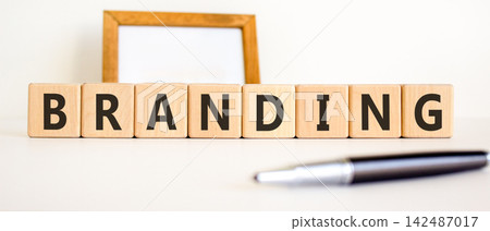 Branding brand word symbol. Concept word Branding on beautiful wooden blocks. Beautiful white background. Beautiful black pen. Business support help branding brand word concept. Copy space. Branding brand word symbol. Concept word Branding on beautiful wooden blocks. Beautiful white background. Beautiful black pen. Business support help branding brand word concept. Copy space. 142487017