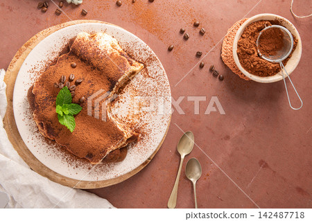 Top view of classic tiramisu cake with cocoa Top view of classic tiramisu cake with cocoa 142487718