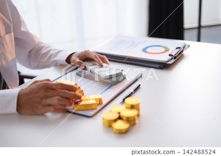 Businessman investing in gold to diversify portfolios hedge against inflation and currency depreciation. Businessman investing in gold to diversify portfolios hedge against inflation and currency depreciation. 142488524