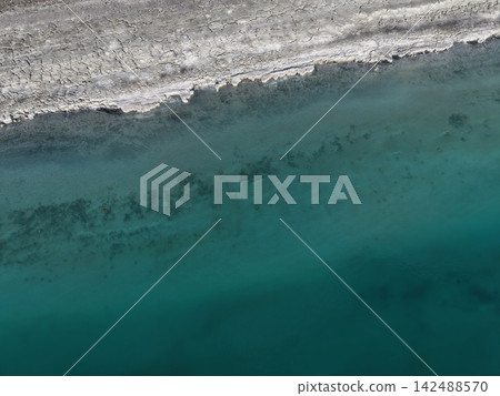 texture, background. aerial view coastli. sunbeams from behind the clouds over the lakes. view from a drone of a lake in the mountains. High quality 4k footage texture, background. aerial view coastli. sunbeams from behind the clouds over the lakes. view from a drone of a lake in the mountains. High quality 4k footage 142488570