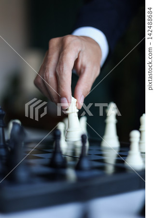 Businessman playing chess game; business strategy, leadership and management concept. Businessman playing chess game; business strategy, leadership and management concept. 142488684