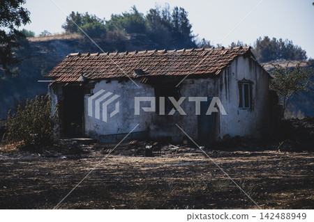 Burned House Surrounded by Wildfire Damage. Burned House Surrounded by Wildfire Damage. 142488949