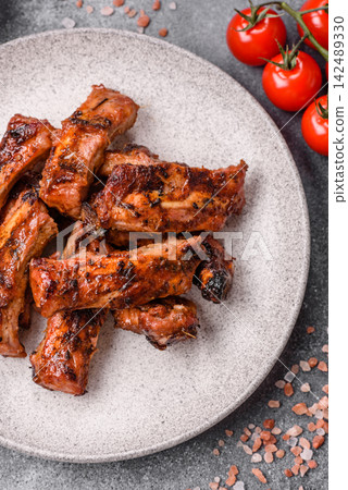 Grilled pork or beef ribs seasoned with salt and spices, served in sauce. Grilled ribs Grilled pork or beef ribs seasoned with salt and spices, served in sauce. Grilled ribs 142489330