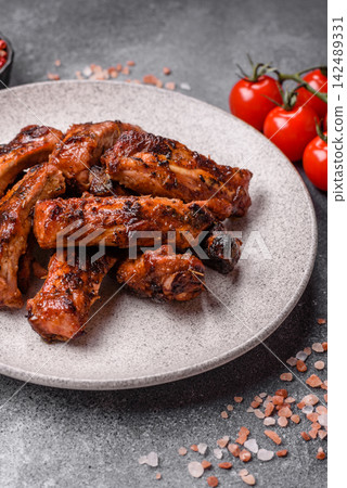 Grilled pork or beef ribs seasoned with salt and spices, served in sauce. Grilled ribs Grilled pork or beef ribs seasoned with salt and spices, served in sauce. Grilled ribs 142489331
