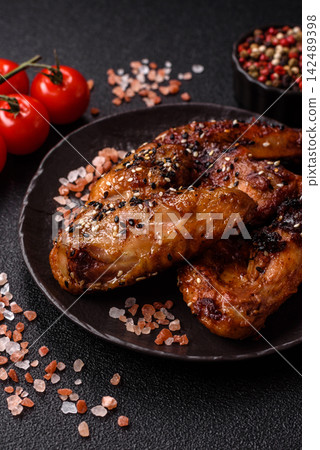 Grilled chicken wings with teriyaki sauce, seasoned with salt and spices. Chicken wings Grilled chicken wings with teriyaki sauce, seasoned with salt and spices. Chicken wings 142489398