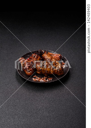 Grilled chicken wings with teriyaki sauce, seasoned with salt and spices. Chicken wings Grilled chicken wings with teriyaki sauce, seasoned with salt and spices. Chicken wings 142489403