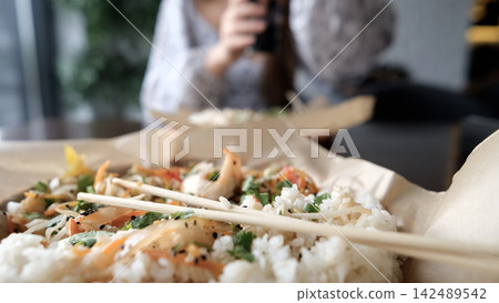Close-up of Caucasian woman eating pan-Asian cuisine Close-up of Caucasian woman eating pan-Asian cuisine 142489542
