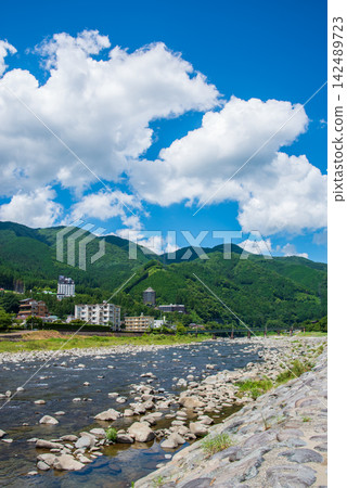 A view of the hot spring town: The Gero mountain range as seen from the Hida River riverbed in Gero Onsen, Gifu Prefecture, Gero City. A view of the hot spring town: The Gero mountain range as seen from the Hida River riverbed in Gero Onsen, Gifu Prefecture, Gero City. 142489723