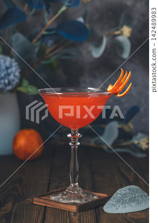 Cocktail in coupe glass with orange peel garnish Cocktail in coupe glass with orange peel garnish 142489983