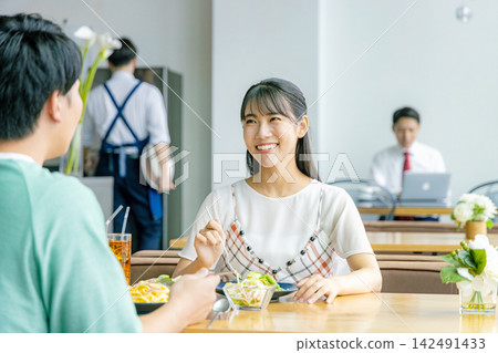 A young couple eating at a cafe A young couple eating at a cafe 142491433