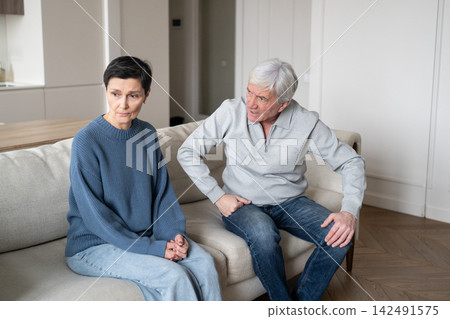 Old couple divorce. Elderly man with hysterical behavior toward upset wife with accusations insults Old couple divorce. Elderly man with hysterical behavior toward upset wife with accusations insults 142491575