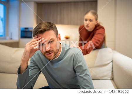 Thoughtful woman partner attempts to make peace with offended husband after family conflict Thoughtful woman partner attempts to make peace with offended husband after family conflict 142491602