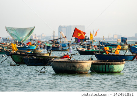Several traditional Vietnamese bamboo basket and fish boats for seafood fishing with gear and nets. Several traditional Vietnamese bamboo basket and fish boats for seafood fishing with gear and nets. 142491881