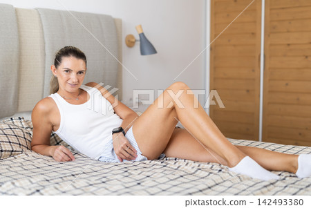 Young woman alone in bedroom, posing and enjoy home time Young woman alone in bedroom, posing and enjoy home time 142493380