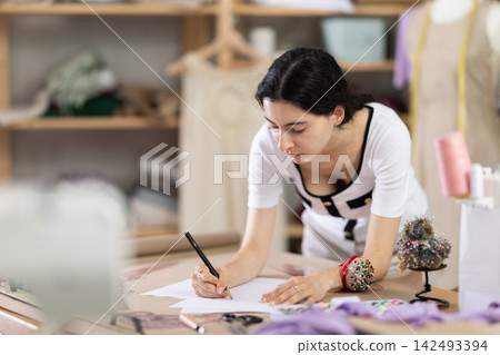 Armenian woman drawing sketch on paper Armenian woman drawing sketch on paper 142493394