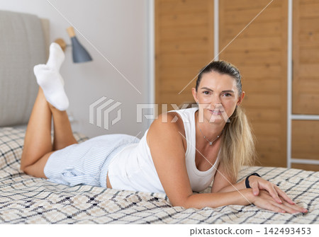Woman posing in bedroom in home clothes Woman posing in bedroom in home clothes 142493453