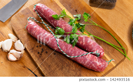 Sausages served with herbs to table Sausages served with herbs to table 142493516