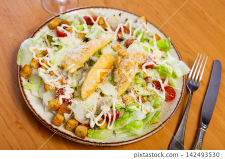 Variation of Caesar salad with chicken, lettuce mix and crackers Variation of Caesar salad with chicken, lettuce mix and crackers 142493530
