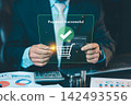 Businessman holding credit card and coins with payment successful hologram interface, mobile banking and online shopping checkout concept. 142493556